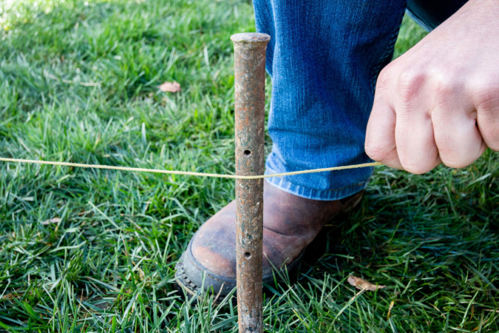 Tying a string onto a stake