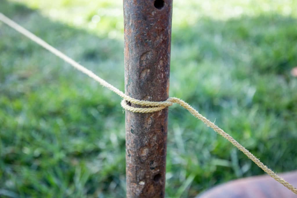 Tying a string onto a stake