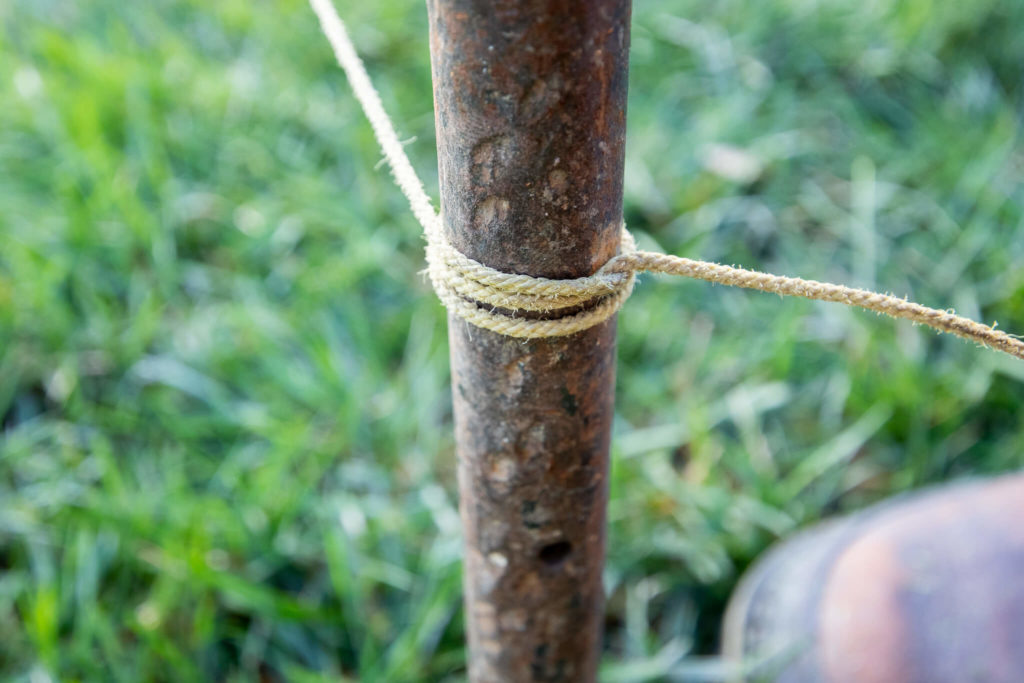 Tying a string onto a stake